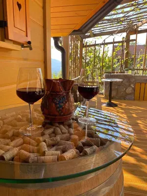 two glasses of wine on a glass table with wine at Holiday home in Drganja sela Kranjska Krain 42002 in Drganja Sela