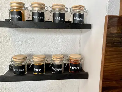 a shelf with jars of jam on a wall at Apartment TiSa, Ljubljana in Ljubljana
