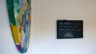 a sign hanging on a wall next to a tie at Apartment TiSa, Ljubljana in Ljubljana