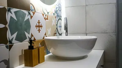 a white sink sitting on a counter in a bathroom at Apartment TiSa, Ljubljana in Ljubljana
