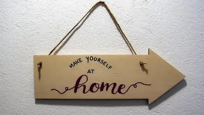 a sign that reads make yourself at home hanging on a wall at Apartment TiSa, Ljubljana in Ljubljana