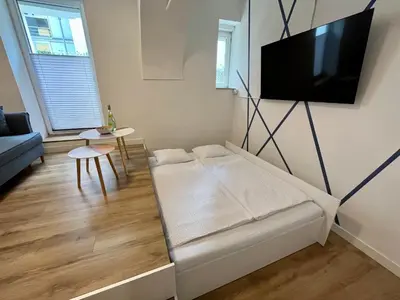 a living room with a couch and a flat screen tv at Apartment TiSa, Ljubljana in Ljubljana