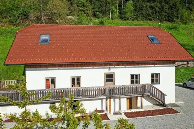a white house with a red roof at Villa Richterberg with Sauna & Hot Tub in Slovenj Gradec