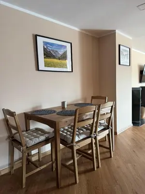 a dining room table and chairs in a room at Apartma LIMA in Mozirje