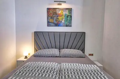 a bedroom with a bed and a painting on the wall at Apartment Ken near Terme Paradiso in Dobova