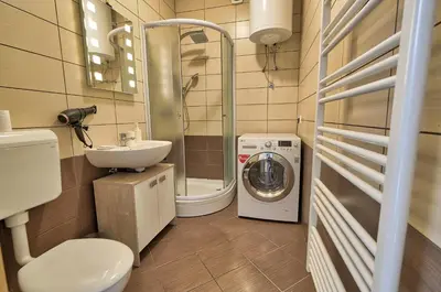 a bathroom with a washing machine and a washer at Apartment Ken near Terme Paradiso in Dobova