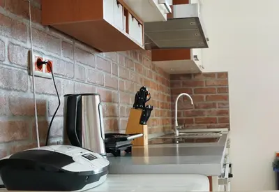 a kitchen with a fax machine on a counter at Apartment Ken near Terme Paradiso in Dobova