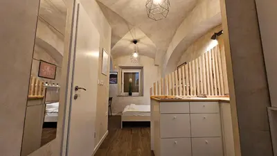 a hallway with a staircase and a room with a sink at Cozy Nest in Ljubljana