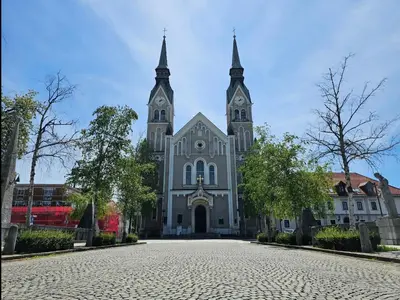 a large white church with two towers on a street at Cozy Nest in Ljubljana