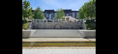 a set of stairs with a stone wall and buildings at Cozy Nest in Ljubljana