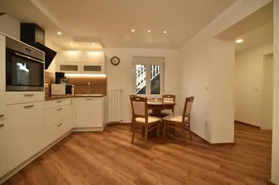 a kitchen and dining room with a table and chairs at SEDAMI in Maribor