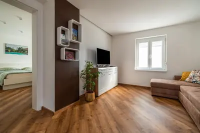 a living room with a couch and a television at SEDAMI in Maribor