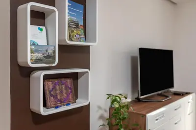 a living room with a tv and a monitor at SEDAMI in Maribor