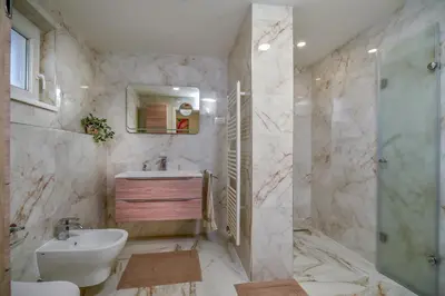 a bathroom with a sink and a toilet and a shower at SEDAMI in Maribor