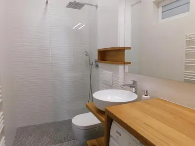 a bathroom with a white toilet and a sink at Boutique Apartment Križanke in Ljubljana