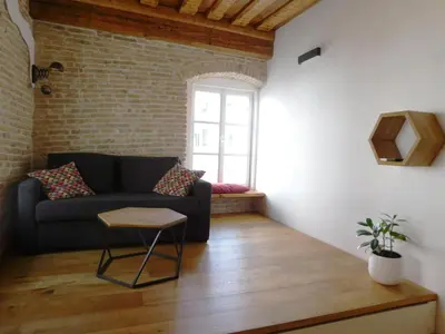 a living room with a couch and a window at Boutique Apartment Križanke in Ljubljana