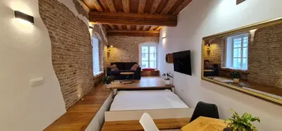 a large living room with a brick wall at Boutique Apartment Križanke in Ljubljana