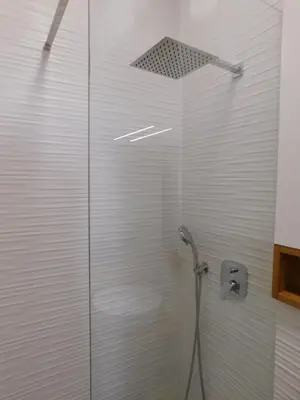 a shower with a glass door in a bathroom at Boutique Apartment Križanke in Ljubljana