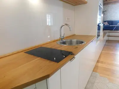 a kitchen with a sink and a wooden counter top at Boutique Apartment Križanke in Ljubljana