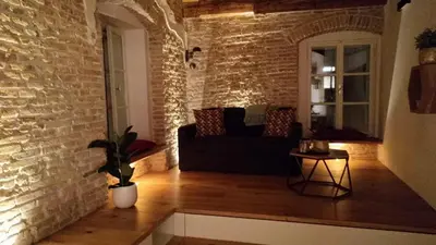 a living room with a couch and a brick wall at Boutique Apartment Križanke in Ljubljana