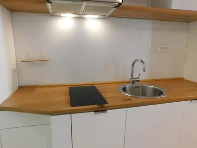 a kitchen counter with a sink and a book on it at Boutique Apartment Križanke in Ljubljana