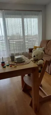 a teddy bear sitting on a chair in a living room at Apartma Vita in Moravske Toplice