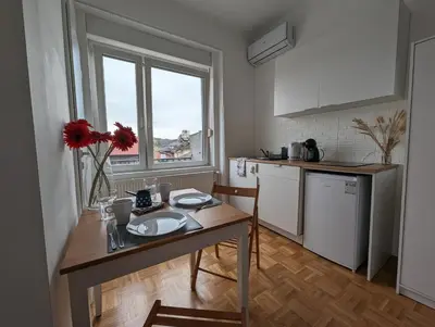 a small kitchen with a table and a counter top at P & B Apartment in Ljubljana