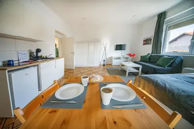 a living room with a table with two plates on it at P & B Apartment in Ljubljana