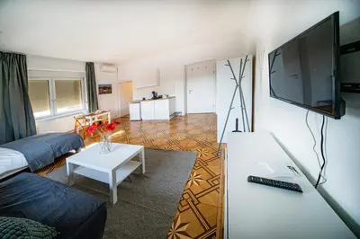a living room with a couch and a tv at P & B Apartment in Ljubljana