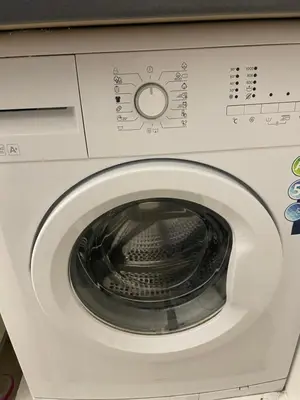 a white washing machine with the door open at Brasilia apartment in Ljubljana