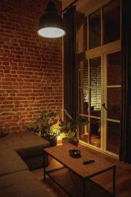 a living room with a couch and a brick wall at Grossmann Apartment in Ljutomer