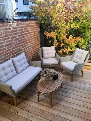 a patio with two chairs and a table and two couches at Grossmann Apartment in Ljutomer