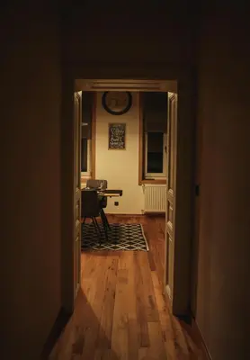 an open door to a room with a table and a desk at Grossmann Apartment in Ljutomer