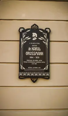 a sign hanging on the side of a house at Grossmann Apartment in Ljutomer