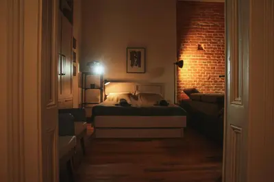 a bedroom with a bed and a brick wall at Grossmann Apartment in Ljutomer