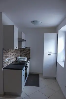 a kitchen with a stove and a white refrigerator at Apartma Praprot in Mojstrana