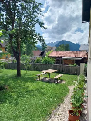 a picnic table in a yard with a tree at Apartma Praprot in Mojstrana