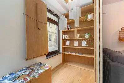 a living room with a couch and a window at Apartma Jenkova rezidenca in Kranj
