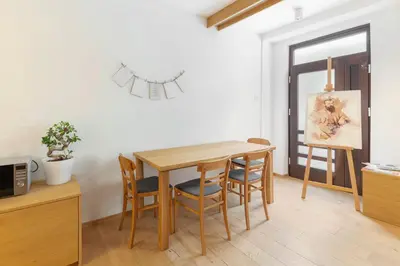 a dining room with a wooden table and chairs at Apartma Jenkova rezidenca in Kranj