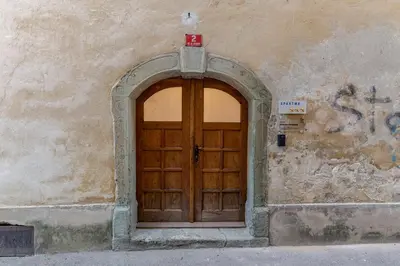 a wooden door in a wall with at Apartma Jenkova rezidenca in Kranj