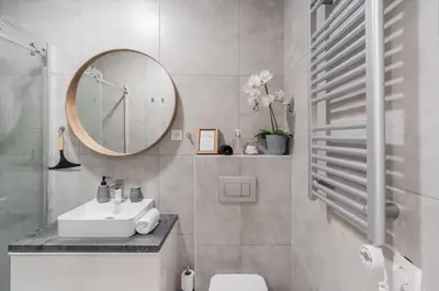 a bathroom with a sink and a mirror at Classy & Cozy apartment in Ljubljana