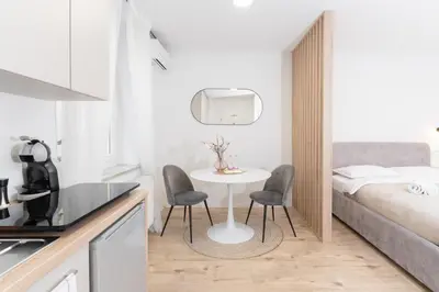 a small kitchen with a table and chairs in a room at Classy & Cozy apartment in Ljubljana