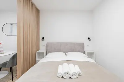 a bedroom with a bed with two towels on it at Classy & Cozy apartment in Ljubljana
