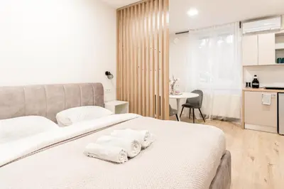 a bedroom with a bed with towels on it at Classy & Cozy apartment 2 in Ljubljana