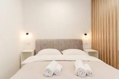 a bedroom with a bed with towels on it at Classy & Cozy apartment 2 in Ljubljana
