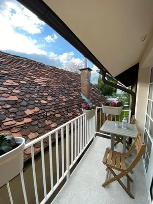 a balcony with a table and a roof at Krakovska apartments in Ljubljana