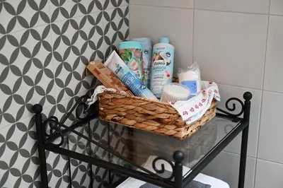 a basket of toiletries on a shelf in a bathroom at Krakovska apartments in Ljubljana