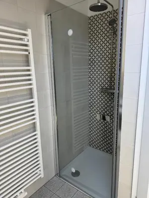 a shower with a glass door in a bathroom at Krakovska apartments in Ljubljana