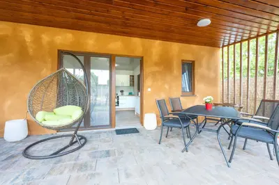 a room with a patio with a table and chairs at Terme Banovci - Mobilne hiške Med Brajdami in Banovci