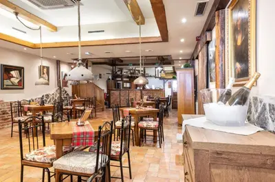 a restaurant with tables and chairs and a bar at Terme Banovci - Mobilne hiške Med Brajdami in Banovci